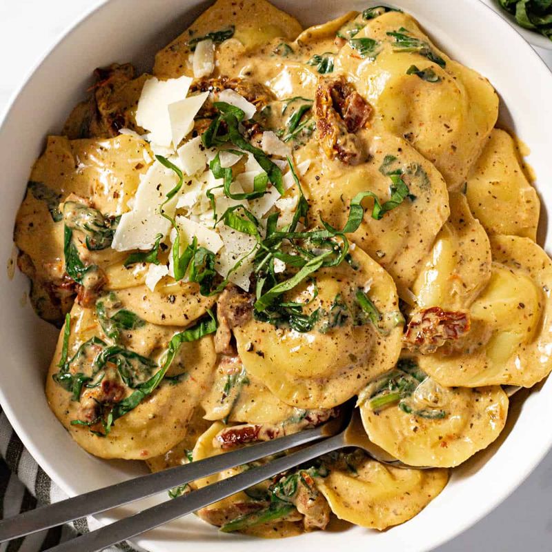 Goat Cheese, Sun-Dried Tomato, and Basil Ravioli With Pesto