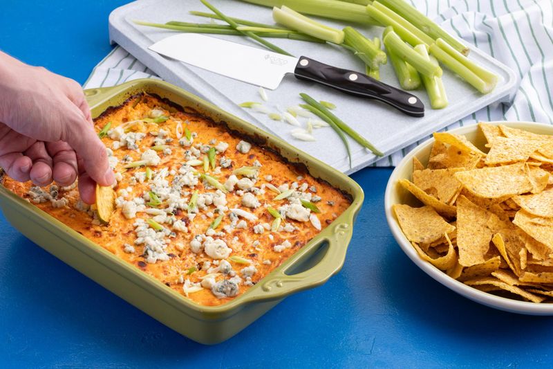 Buffalo chicken dip with chips and celery