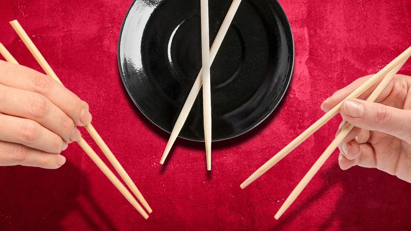 Pointing, waving, or gesturing with chopsticks