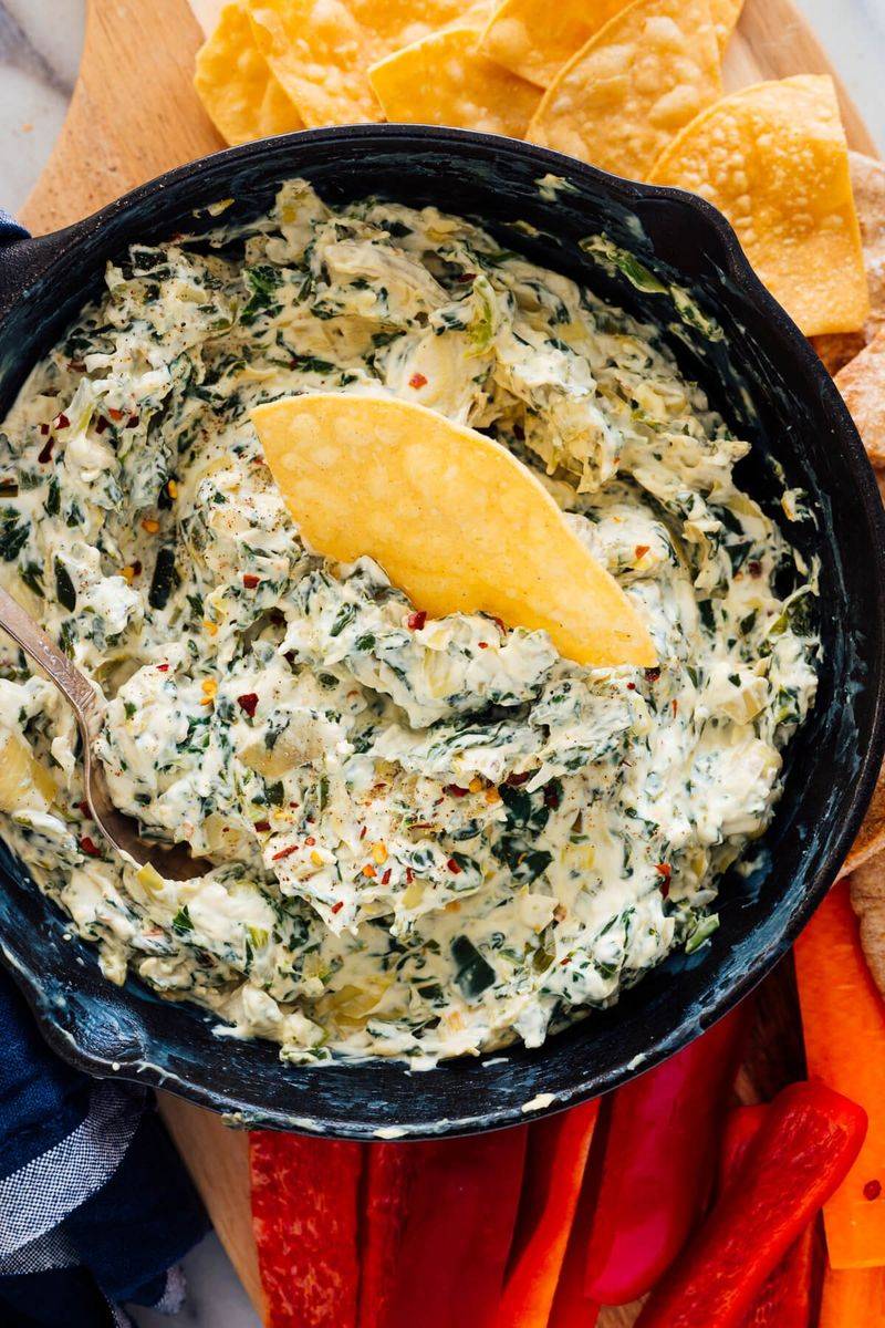 Spinach artichoke dip with chips and bread