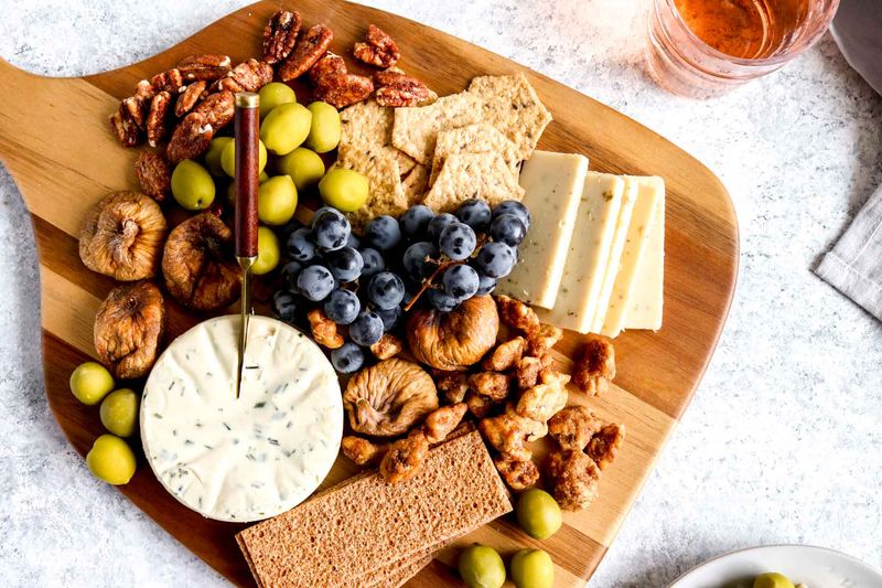 Mini snack plate with olives, cheese, grapes, and nuts