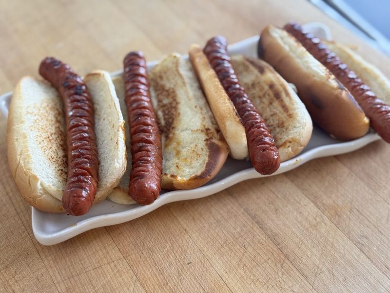 Score the hot dogs before cooking