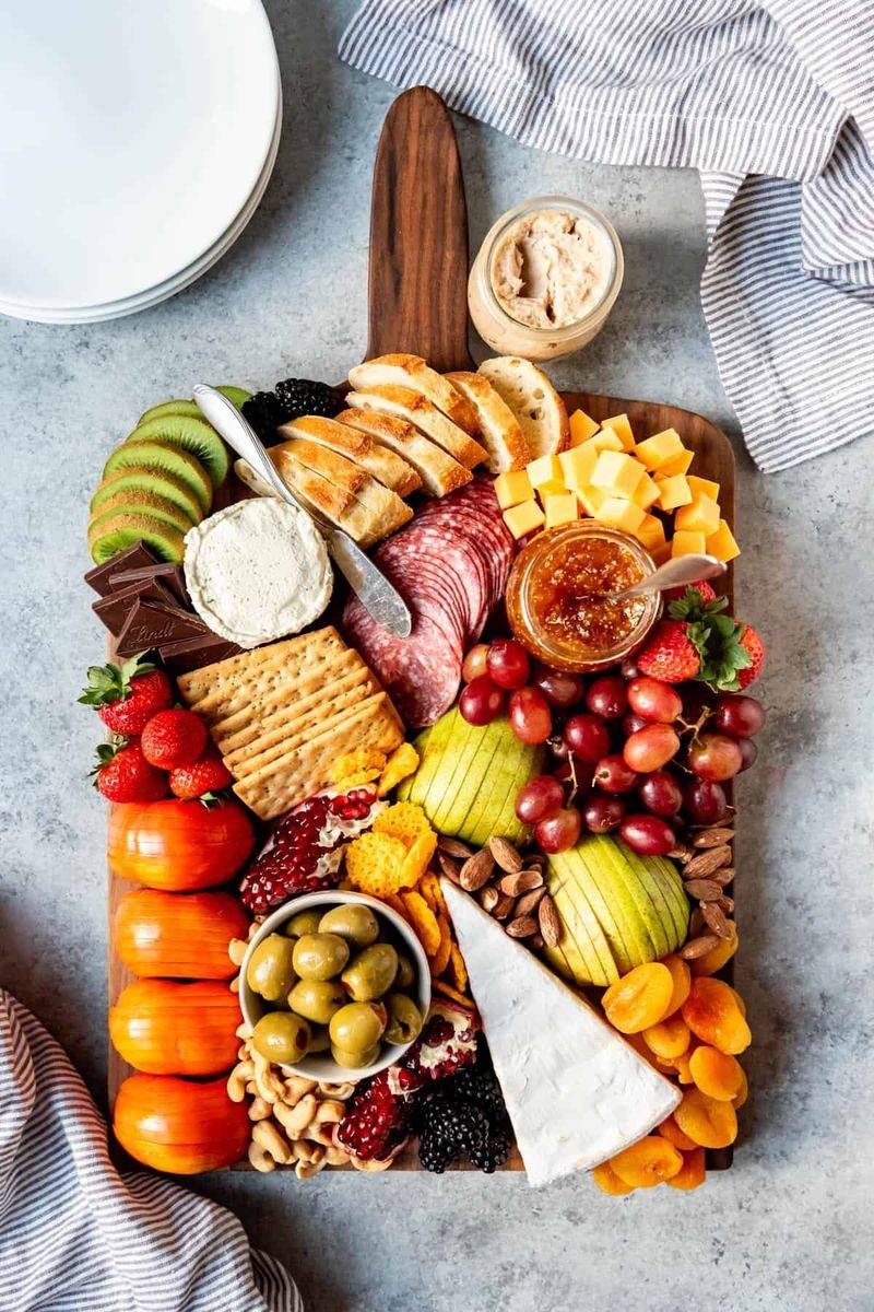 Cheese board with crackers and grapes