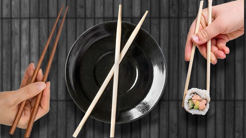 Pointing with chopsticks or using them like a spear