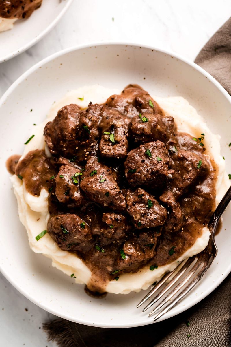 Beef Tips in Gravy Over Mashed Potatoes
