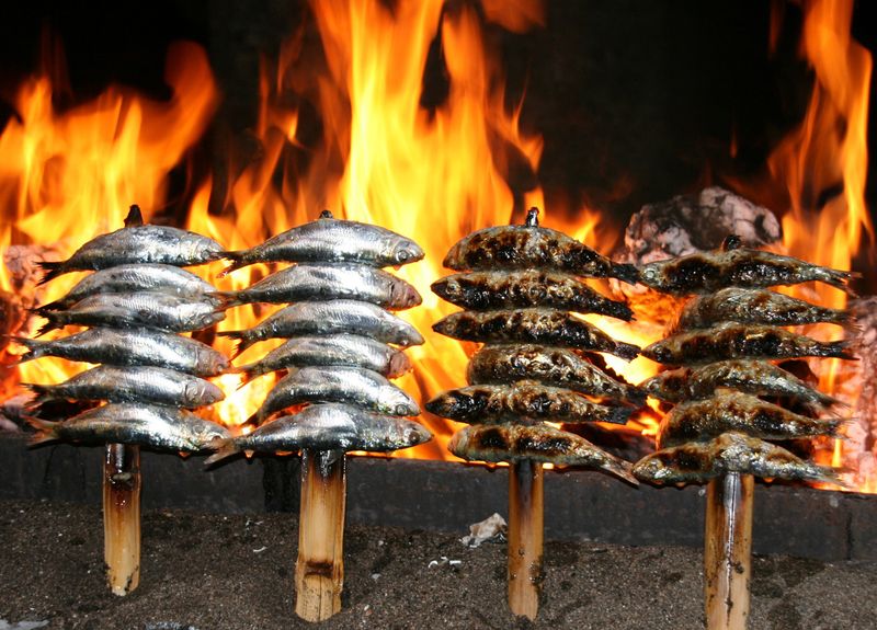 Sardines grilled over open flame