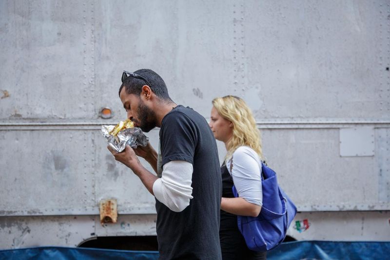 Eating while walking where it is frowned upon