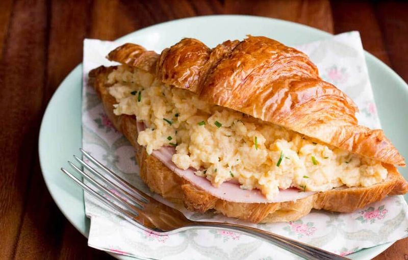 Breakfast croissant with scrambled eggs and cheddar