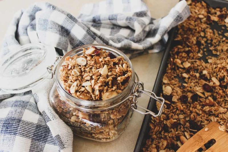 Granola ingredients over bagged granola