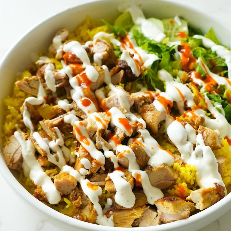 Halal Cart Chicken and Rice Flooded with White and Hot Sauce