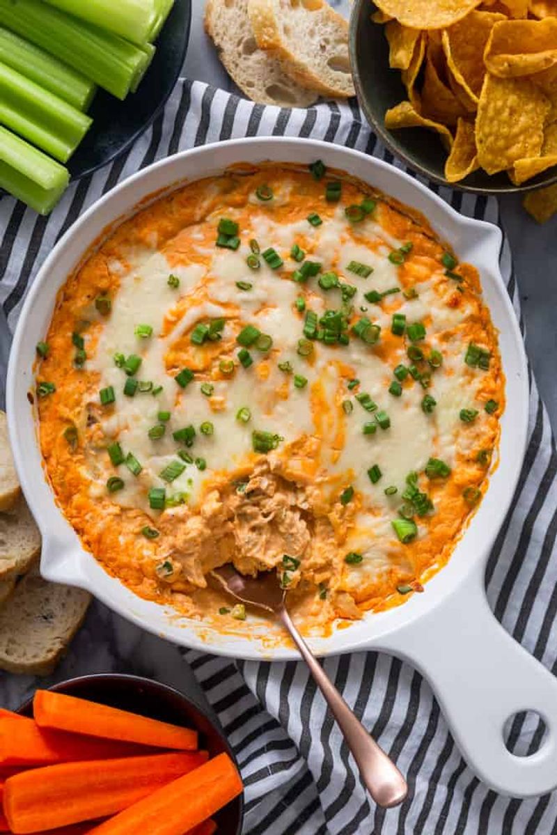 Buffalo chicken dip with chips and celery