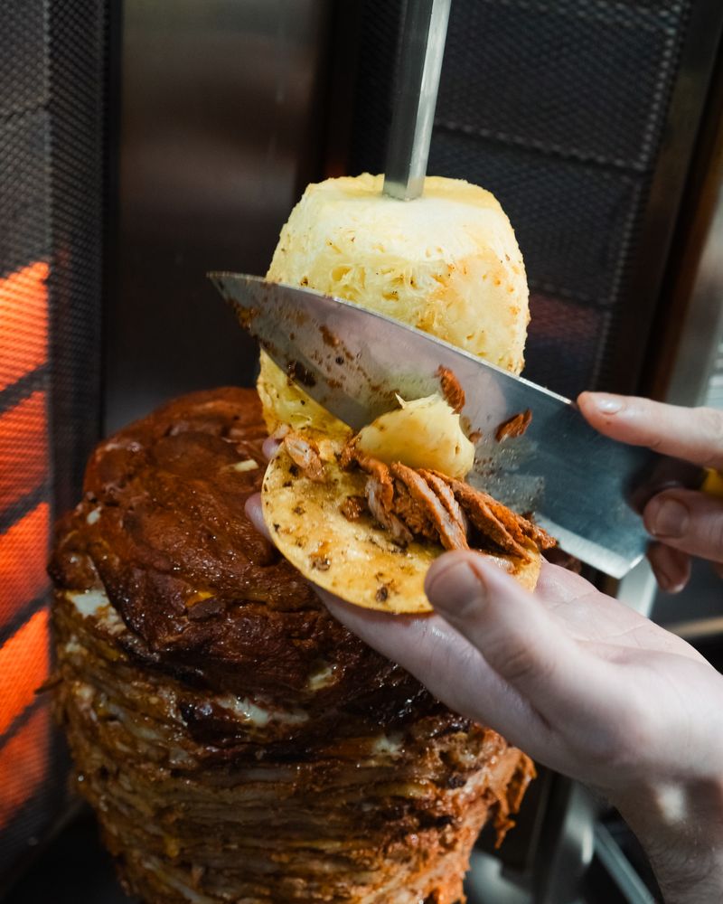 Sizzling al pastor on a trompo