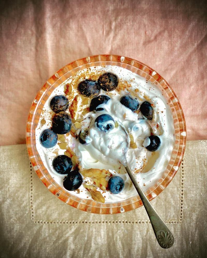 Greek yogurt bowl with berries and chopped nuts