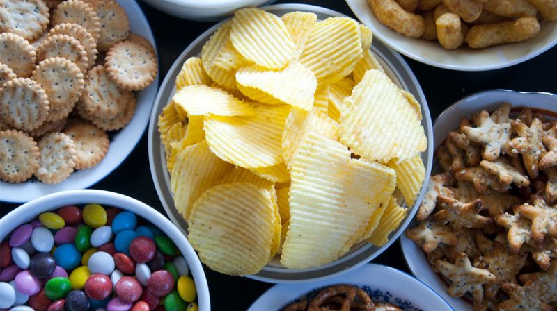 Packaged crackers and chips with low-quality oils