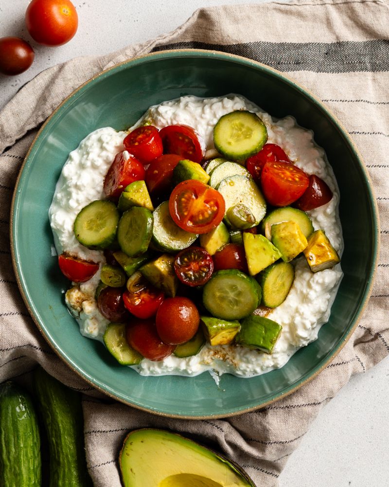 Cottage cheese with sliced cucumber and tomatoes