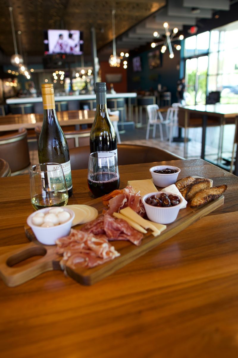 Overpriced charcuterie boards with sad crackers