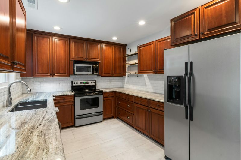 Kitchen Features That Could Make Your Space Feel Dated - Decor Hint Speckled Granite Countertops