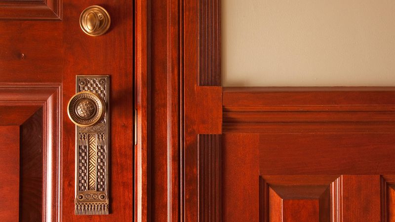 Paneled Wood Doors with Brass Hardware