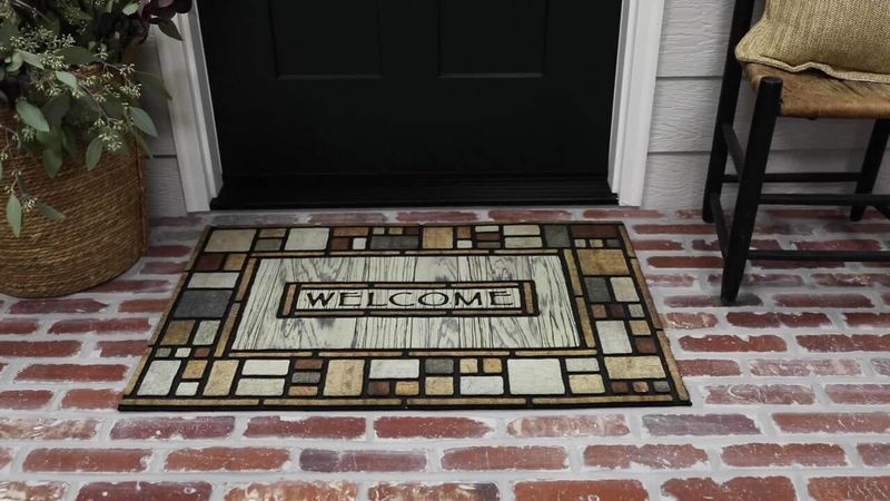 9 Items That Designers Say Should Never Be On Your Porch (And 8 That Should Be) - Decor Hint Torn or Faded Welcome Mats