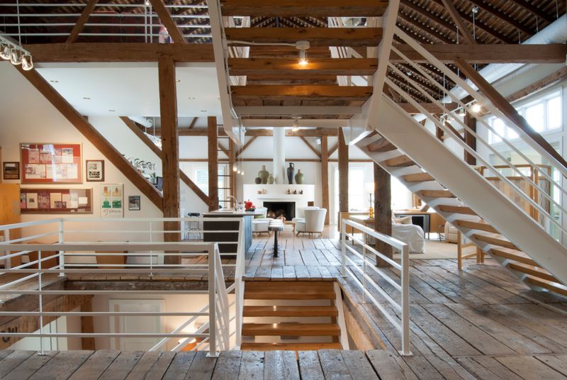22 Fancy Barndominium Homes That Beautifully Mix Rustic With Modern - Decor Hint Open Metal Staircase Against Barn Walls