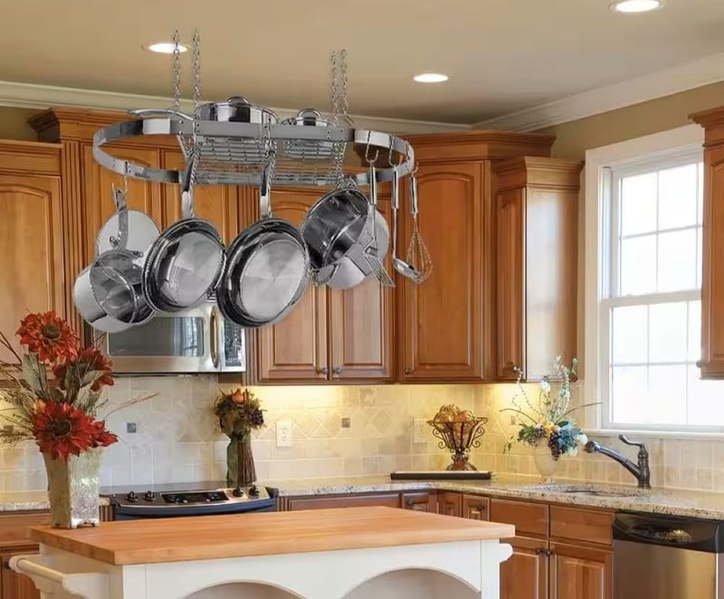 12 Impractical Kitchen Trends Interior Designers Say Won't Last In 2025 (Plus 7 Already Losing Their Momentum) - Decor Hint Suspended Pot Racks That Collect Dust