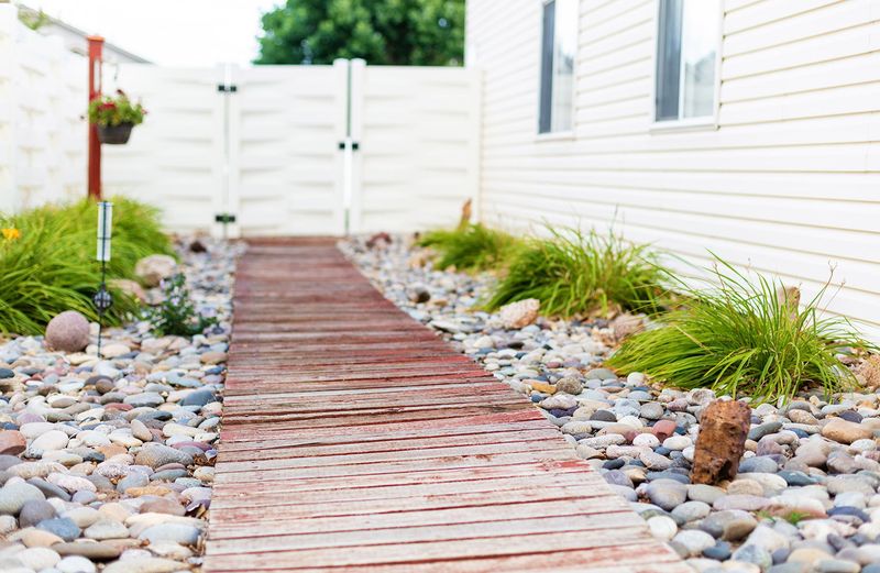 12 Coastal-Inspired Curb Appeal Ideas Seen In California Homes (And 3 That Are Losing Charm Fast) - Decor Hint Shell and Pebble Pathways