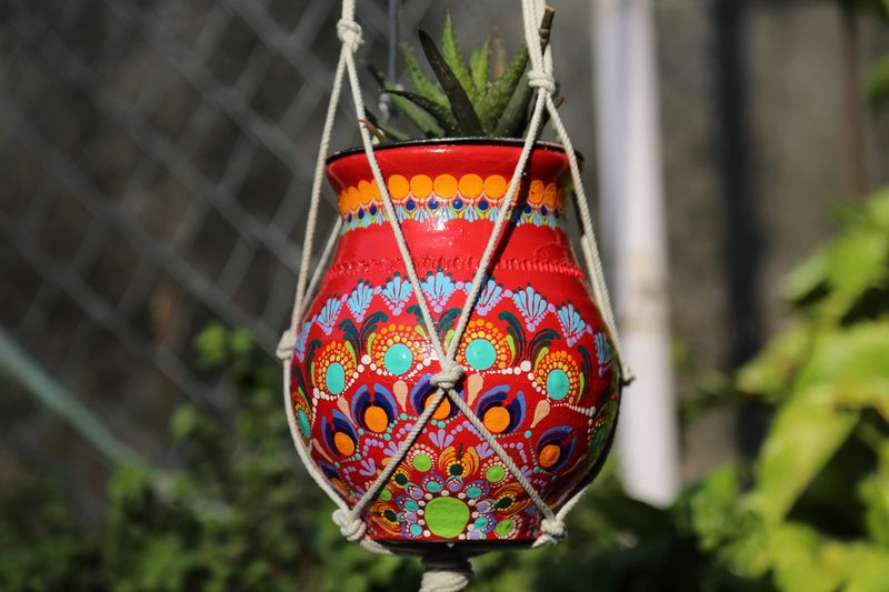 11 Gorgeous Garden Wall Decorating Ideas For A Perfect Outdoor Space - Decor Hint Colorful Hanging Pottery