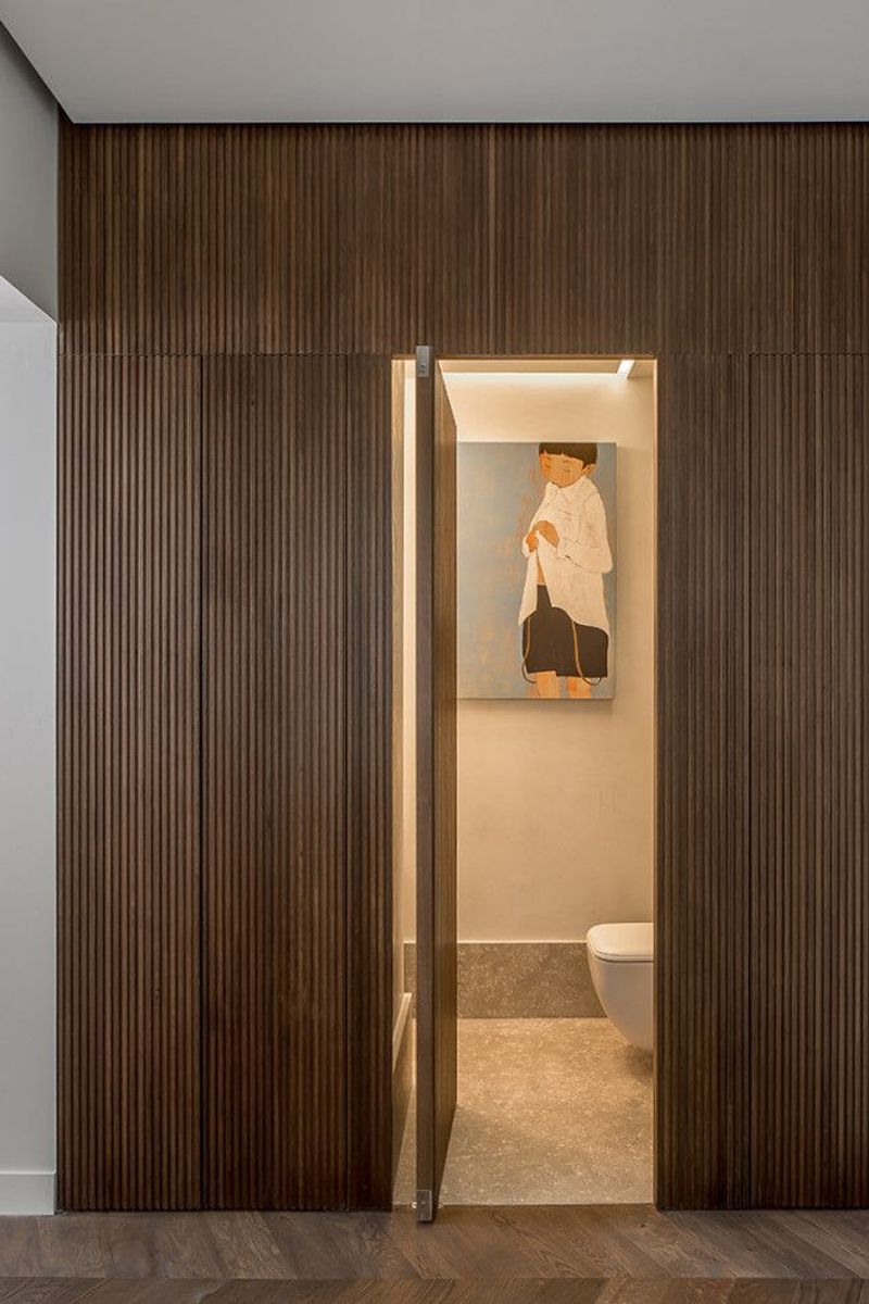 16 Ways How Designers Use Hidden Doors: The Whimsical Trend That Can Actually Be Very Practical - Decor Hint Wall Panel That Conceals a Bathroom