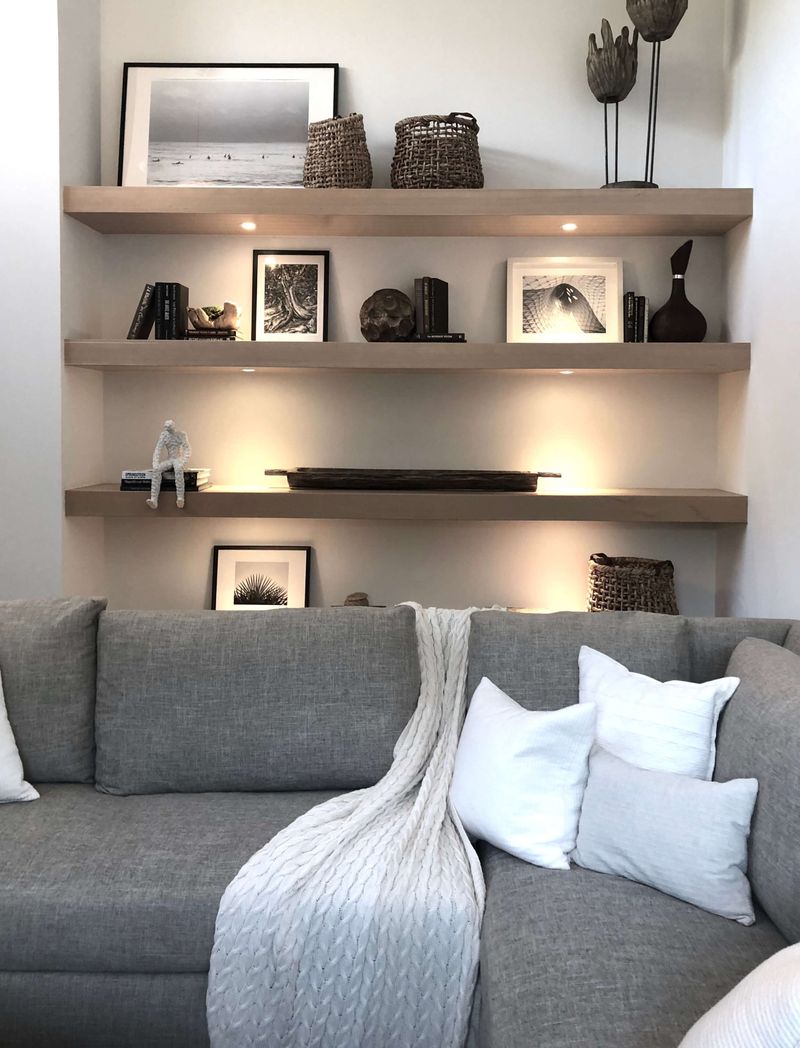 16 Tiny Room Layouts That Just Work - Decor Hint Sofa Against the Long Wall with Floating Shelves Above