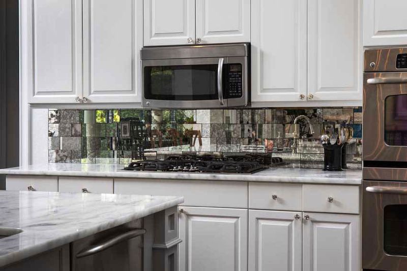11 Simple Changes That Make A Small Kitchen Feel Spacious - Decor Hint Install a Mirror Backsplash