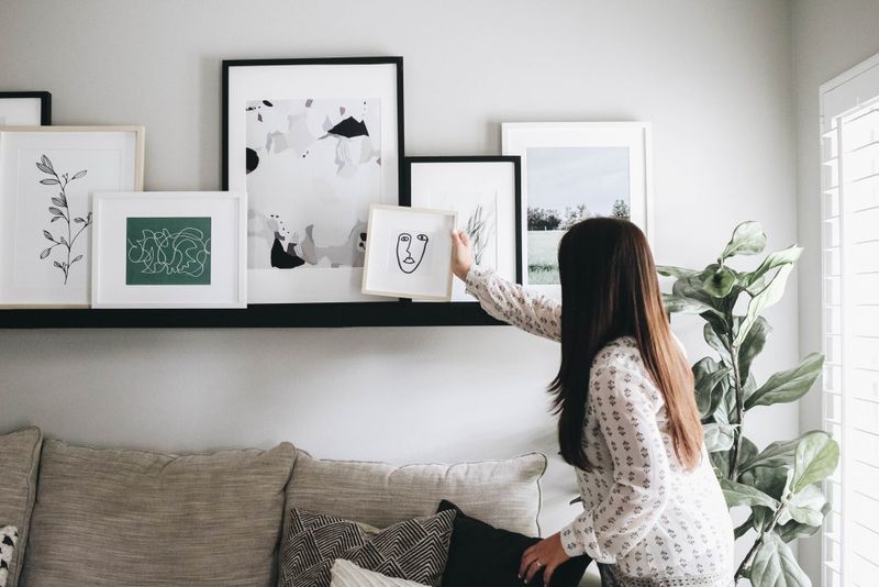Designer Secrets: 8 Items You Should Absolutely Avoid Displaying On Your Living Room Shelves - Decor Hint Overwhelming Photo Clusters