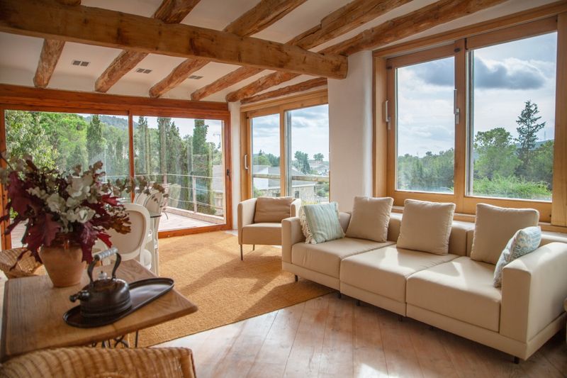 14 Mediterranean-Inspired Living Spaces That Bring A European Getaway Home - Decor Hint Room Accented With Exposed Wooden Beams