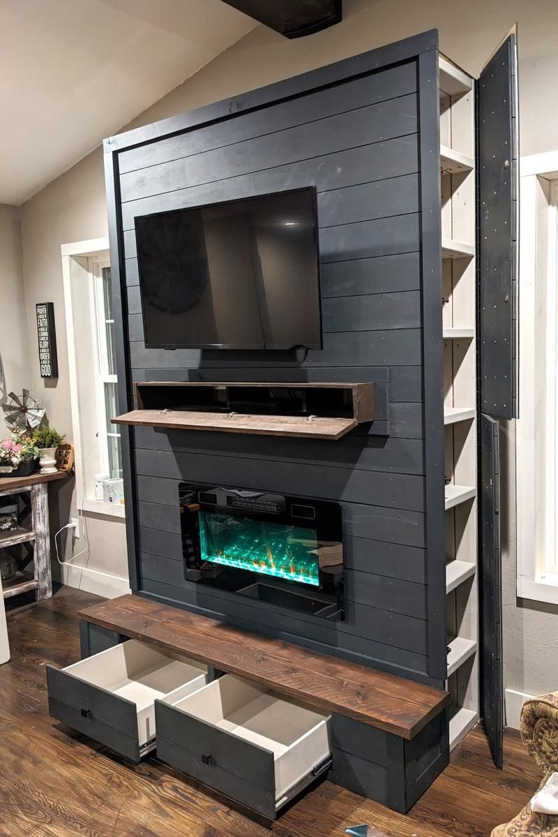 16 Ways How Designers Use Hidden Doors: The Whimsical Trend That Can Actually Be Very Practical - Decor Hint Faux Fireplace Opening to Storage