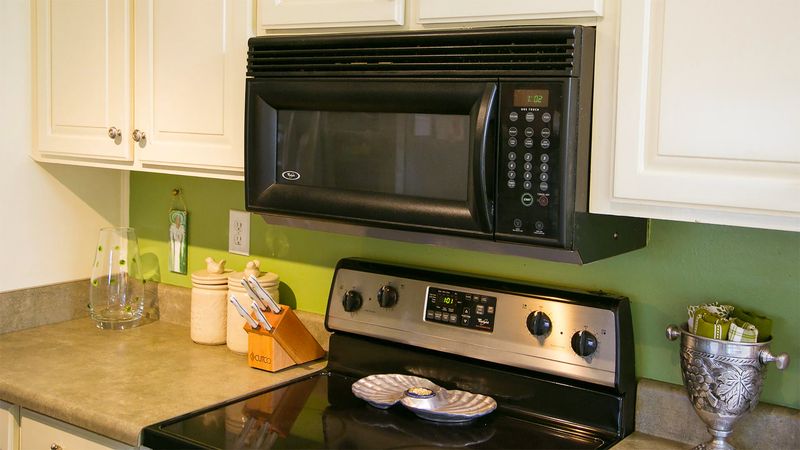 29 Kitchen "Icks" That Immediately Turn Off Homebuyers, According to Interior Designers - Decor Hint Over-The-Stove Microwave