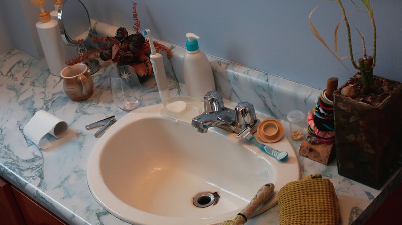 18 Nostalgic Home Trends That Ruin Boomers' Homes - Decor Hint Bathroom Countertop Toiletries