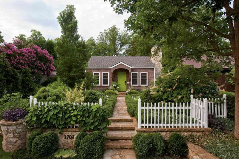 11 Country-Inspired Curb Appeal Ideas From Kentucky Homes - Decor Hint Stone Pathway Bordered by Wildflowers