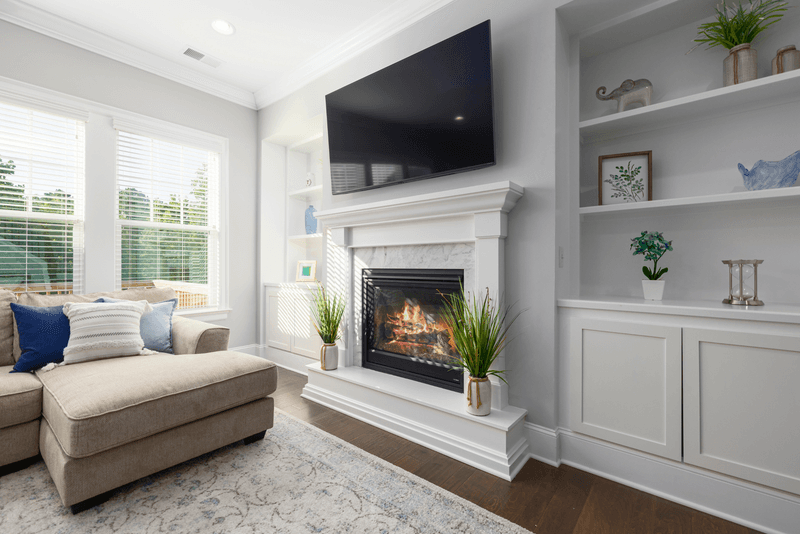 22 Clear Signs Your Home Is Not Trendy Anymore, According To Designers - Decor Hint TV Above Fireplace Creates Neck Pain