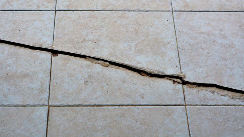 29 Kitchen "Icks" That Immediately Turn Off Homebuyers, According to Interior Designers - Decor Hint Cracked Tile Flooring