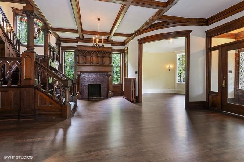 Grand Entryway Welcomes With Hand-Carved Woodwork And Vintage Lighting