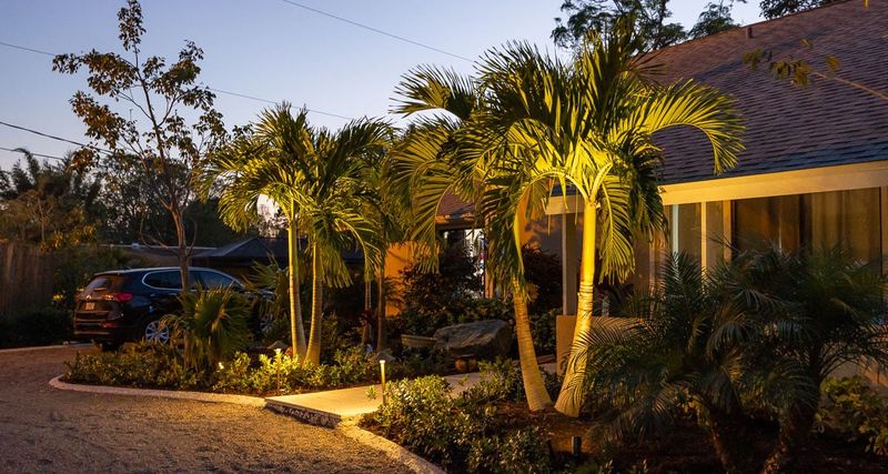 12 Stunning Outdoor Spaces Turning Heads Across Florida Neighborhoods - Decor Hint Tropical-Themed Patios With Lush Palm Landscaping