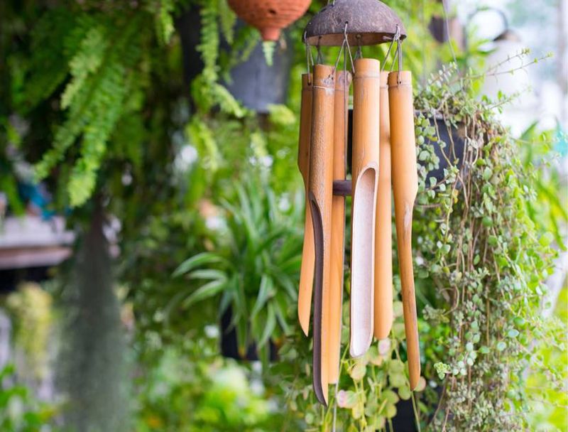 21 Landscaping Features That Are Really Annoying Your Neighbors, Real Estate Pros Say - Decor Hint Towering Wind Chimes