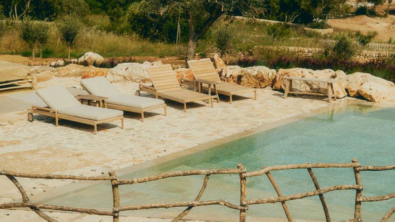 Pool Area With Low-Slung Loungers And Raw Edges