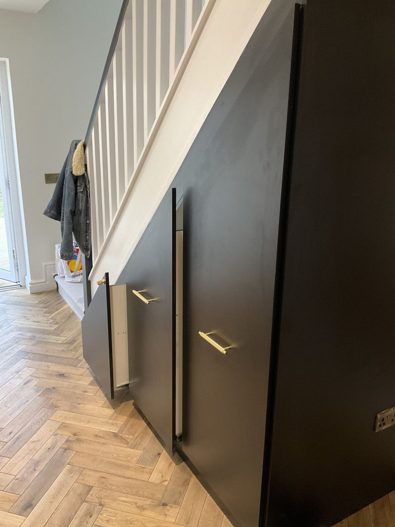 16 Ways How Designers Use Hidden Doors: The Whimsical Trend That Can Actually Be Very Practical - Decor Hint Under-Stair Storage with Hidden Panels