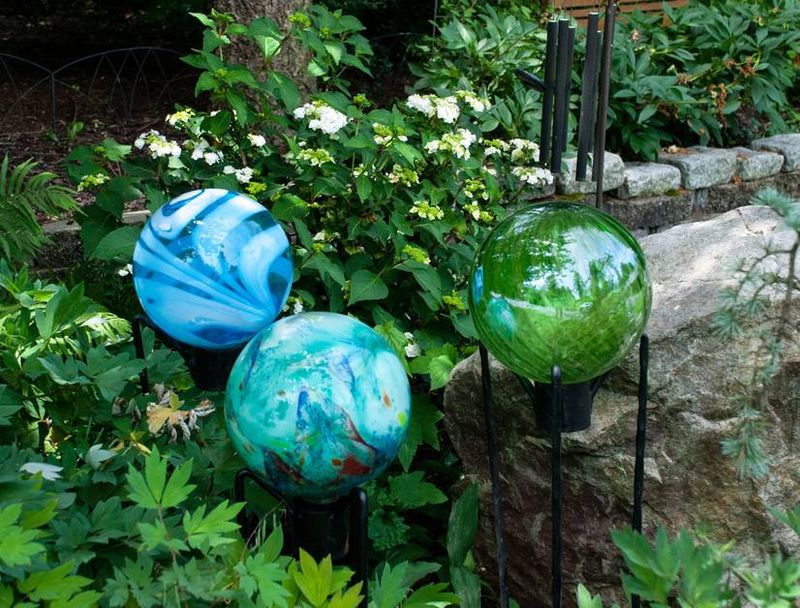 These 20 Garden Decor Ideas Are The Little Details That Will Make The Biggest Difference In Your Outdoor Space - Decor Hint Gazing Balls in Unexpected Colors