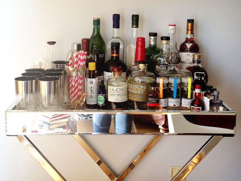 Designer Secrets: 8 Items You Should Absolutely Avoid Displaying On Your Living Room Shelves - Decor Hint Empty Alcohol Bottles