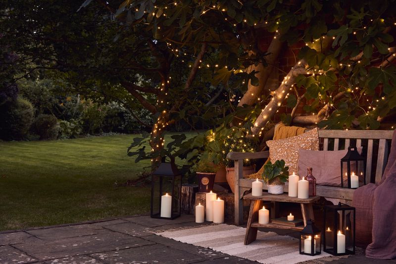 15 Backyard Micro-Oasis Ideas For Small Outdoor Spaces - Decor Hint String Lights and Lanterns