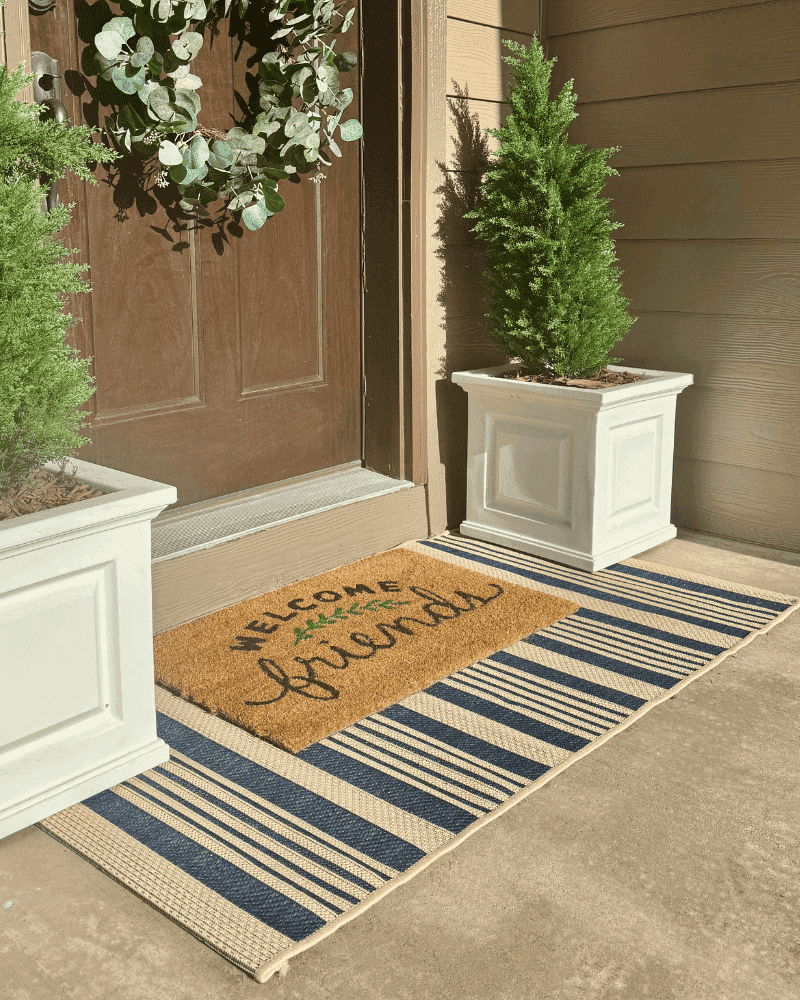 12 Front Porch Looks That Define South Carolina Welcoming Style - Decor Hint Layered Doormats and Welcome Signs