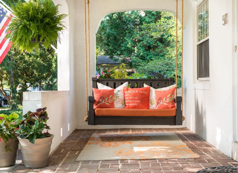 14 Entryway Ideas That Instantly Elevate Georgia Homes - Decor Hint Porch swing visible through the door