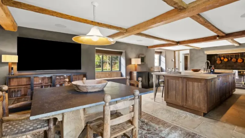 Exposed Beams And Limestone Walls Set A Rustic-Luxe Tone