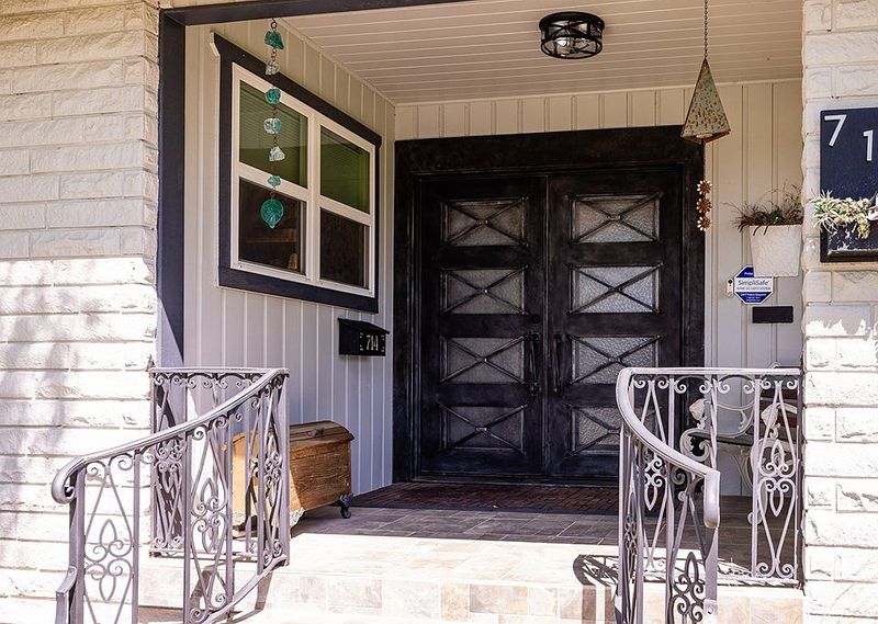 Oversized Front Doors with Iron or Wood Detailing